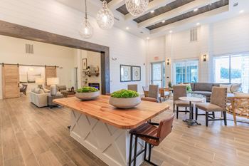 A modern dining room with a wooden table and chairs.