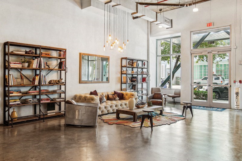 A room with a white wall and a large window.