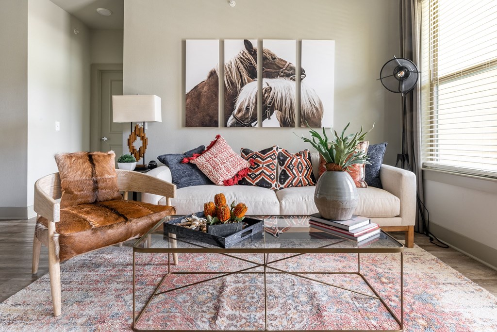 a living room filled with furniture and a large window