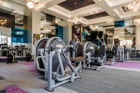a gym with cardio machines and weights in the lobby of a building