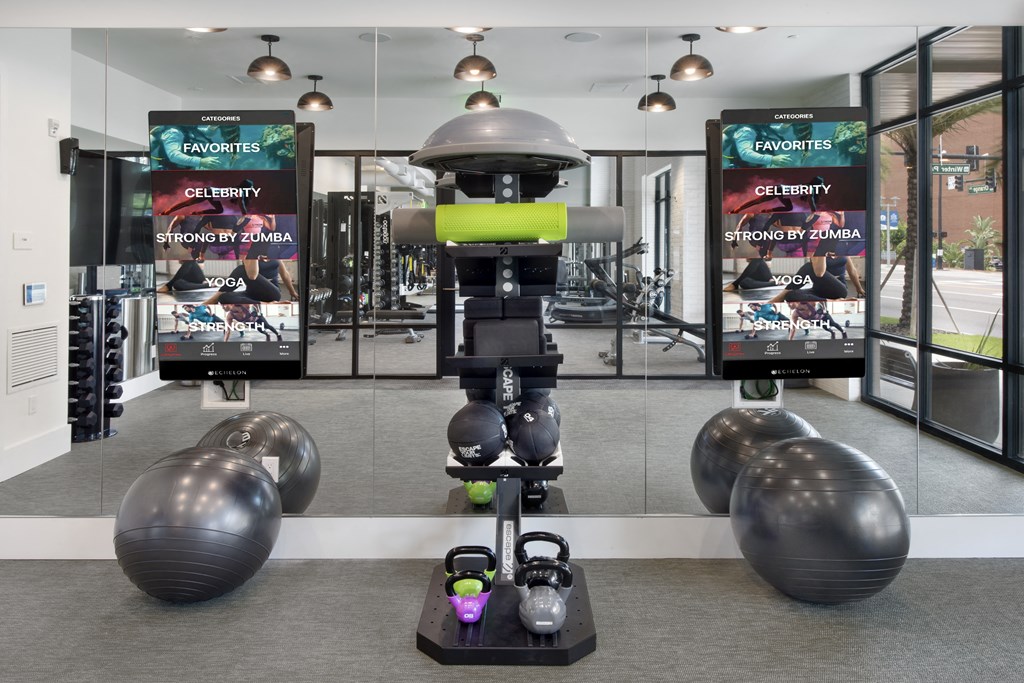 a robot in a gym with weights and other exercise equipment