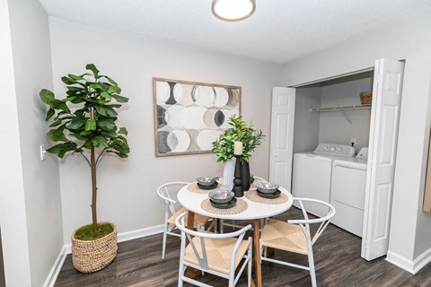 our apartments offer a dining room with a small table and chairs