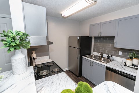 a kitchen with stainless steel appliances and a white counter top