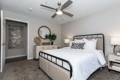 a bedroom with a bed and a ceiling fan