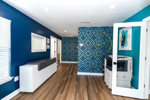 A room with a blue wall and a white cabinet.