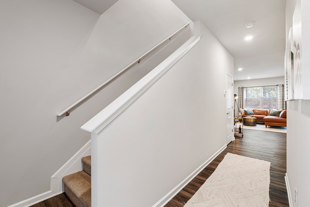 A white staircase with a beige carpet on the floor.