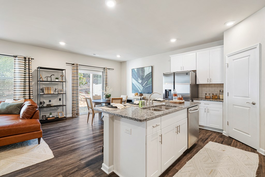 A modern kitchen with white cabinets and a central island.