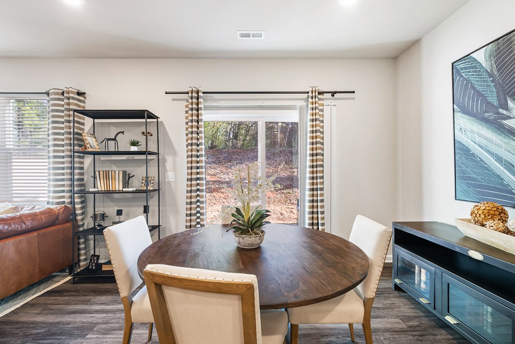 A modern dining room with a wooden table and chairs.