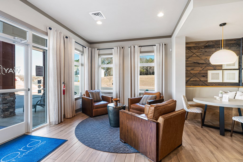 A modern living room with a stone wall and a fireplace.