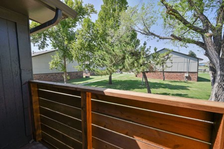 A wooden fence in the foreground with a residential area in the background.