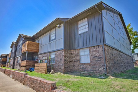 A modern house with a combination of brick and siding exterior.