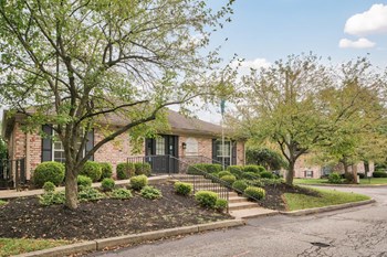 Exterior of leasing office with wooded area. - Photo Gallery 9