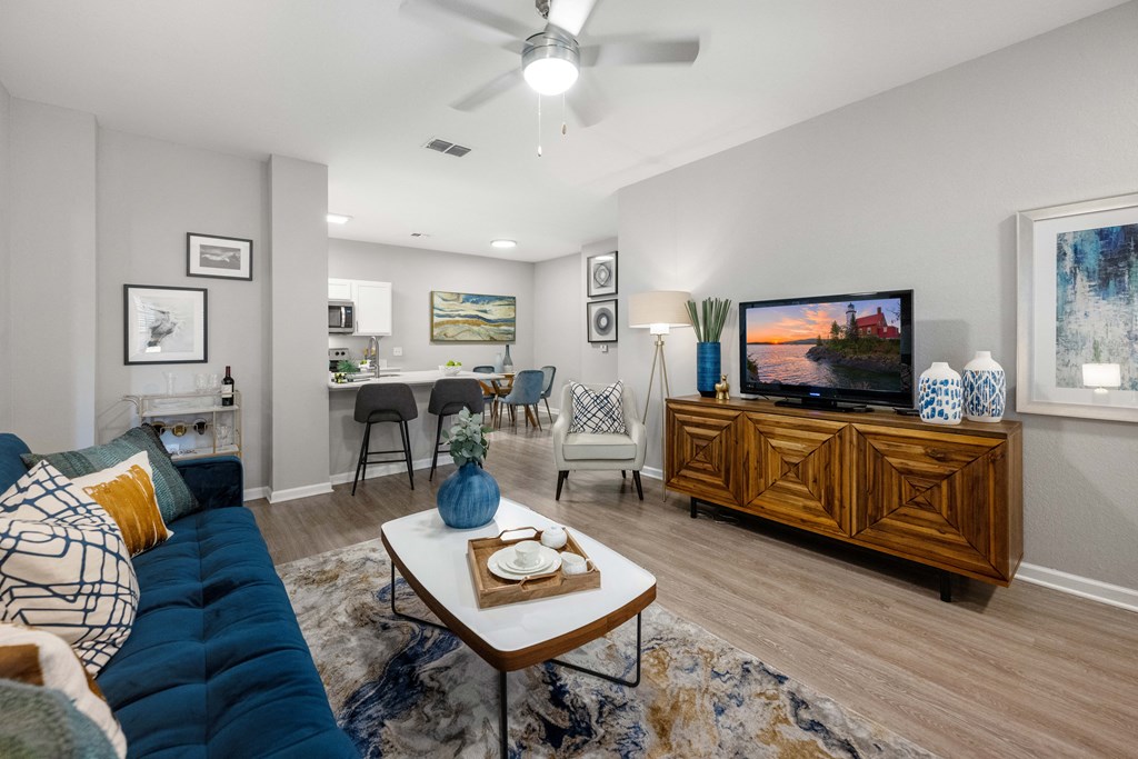 a living room with a blue couch and a tv