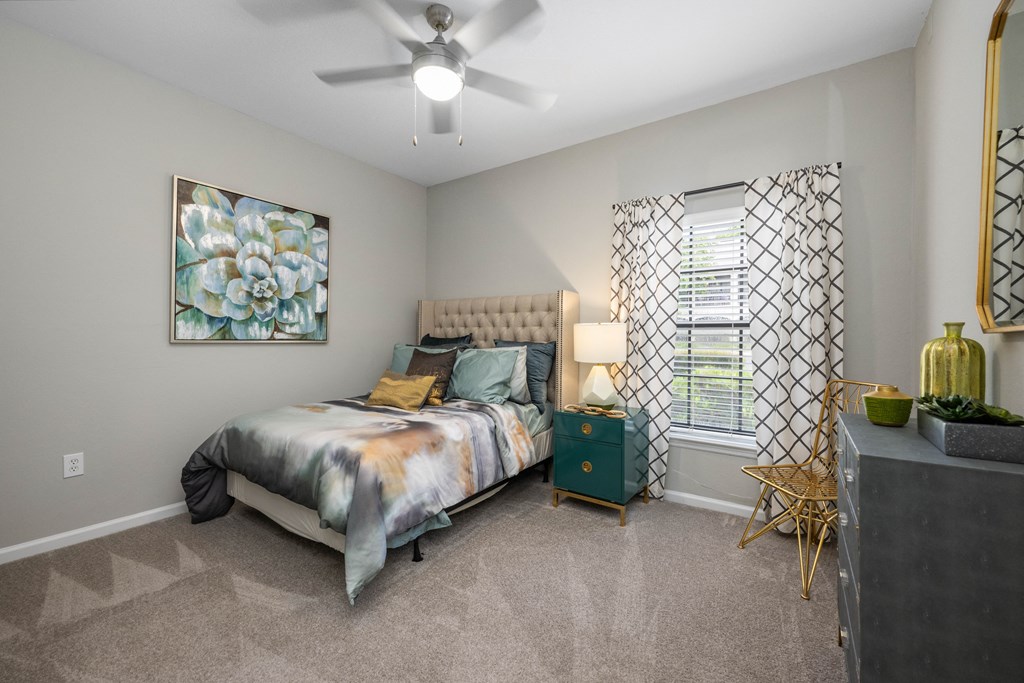 a bedroom with a bed and a ceiling fan