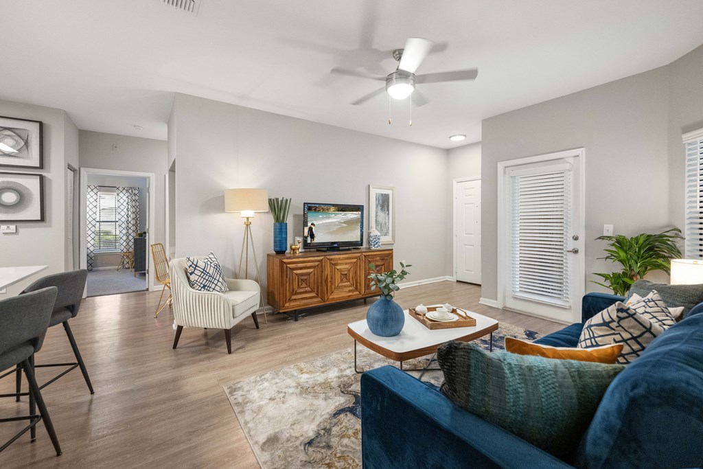 a living room with a ceiling fan and a couch