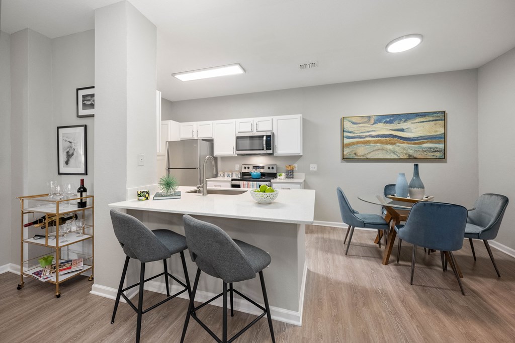 an open kitchen and dining area with a table and chairs
