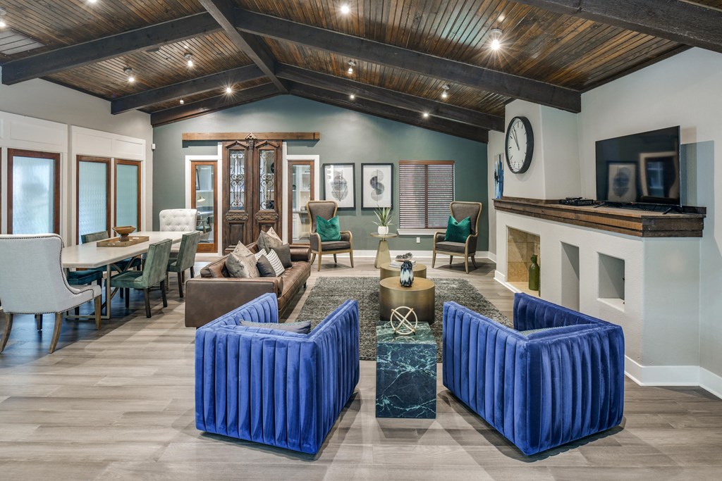 a living room with blue furniture and a fireplace