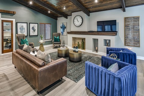 a living room with couches and chairs and a fireplace