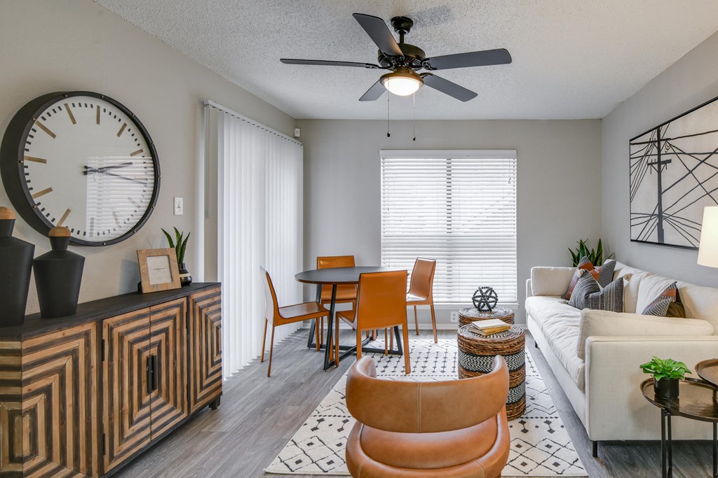 our living room and dining room with a large clock on the wall