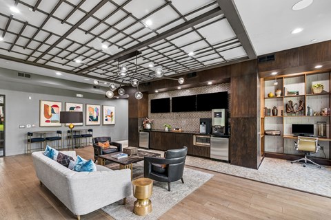 A modern living room with a grey sofa and a wooden cabinet.