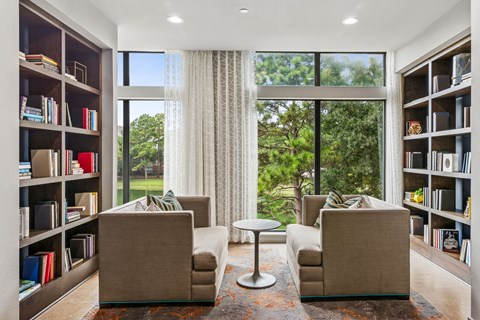 A living room with two couches and a table in front of a large window.
