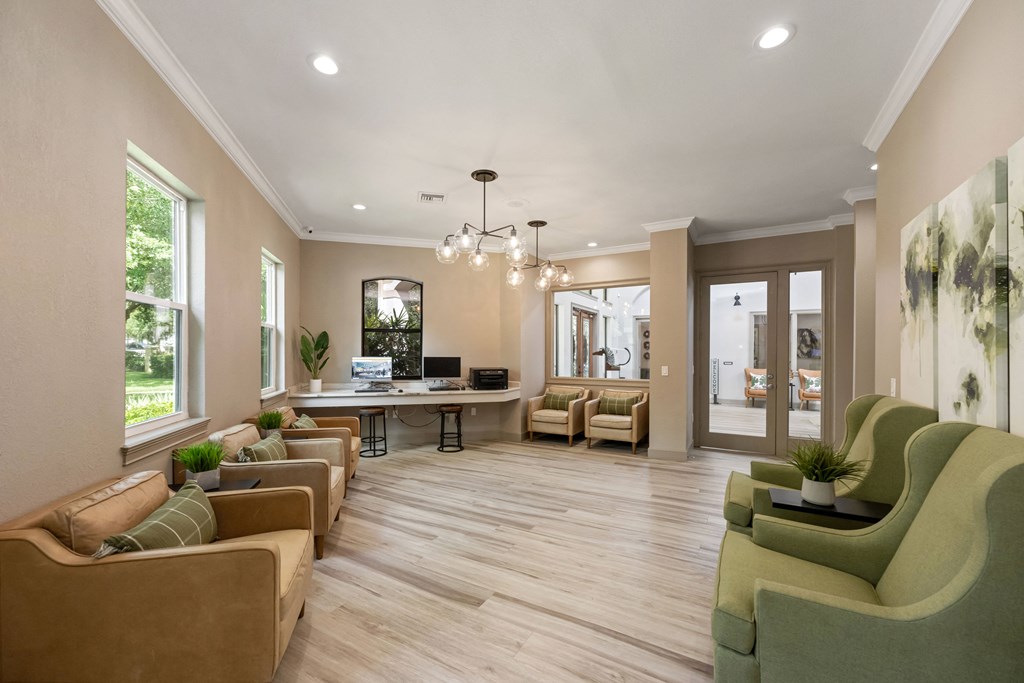 a living room with couches and chairs and a desk