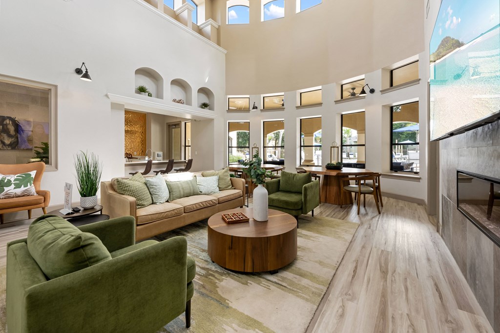 a living room with couches and chairs and a table