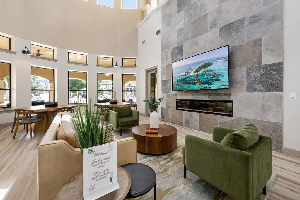 a living room with couches and chairs and a fireplace