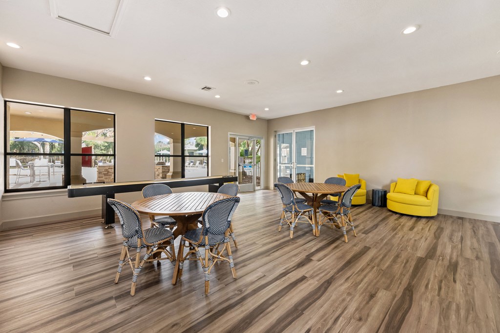 a dining room with a table and chairs and a large window