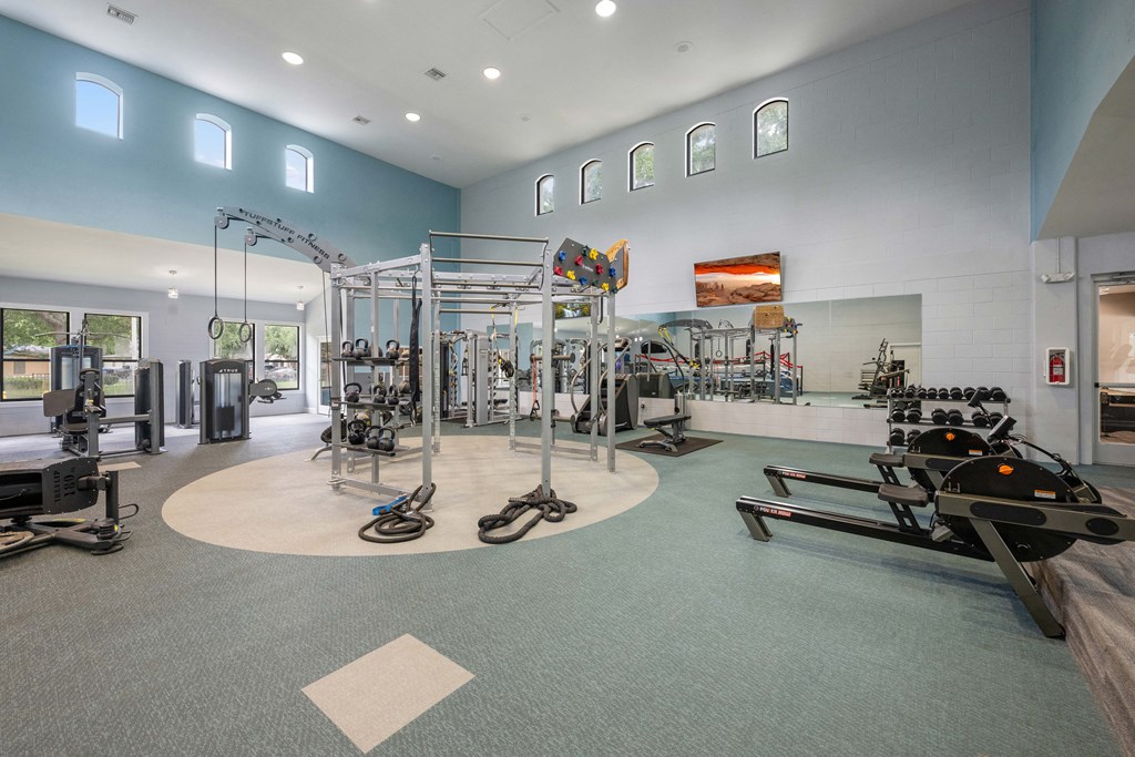 the gym at the flats at obsidian development has weights machines and other exercise equipment