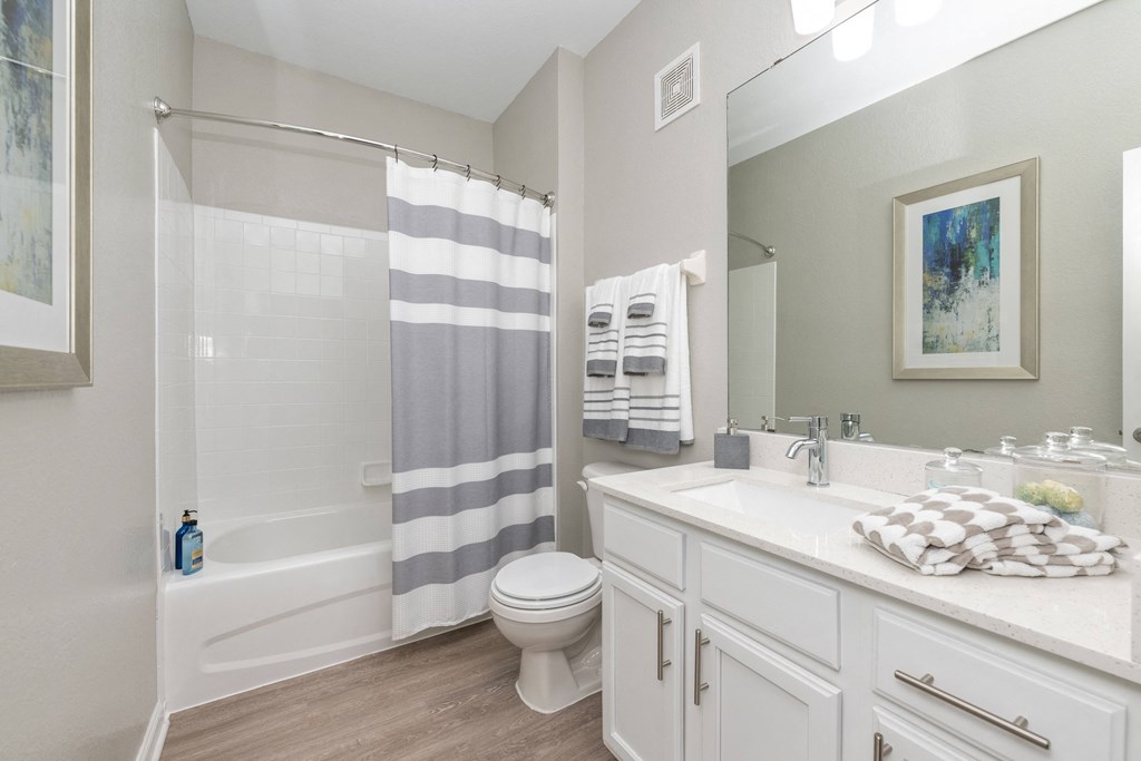 a bathroom with a shower and a sink and a toilet