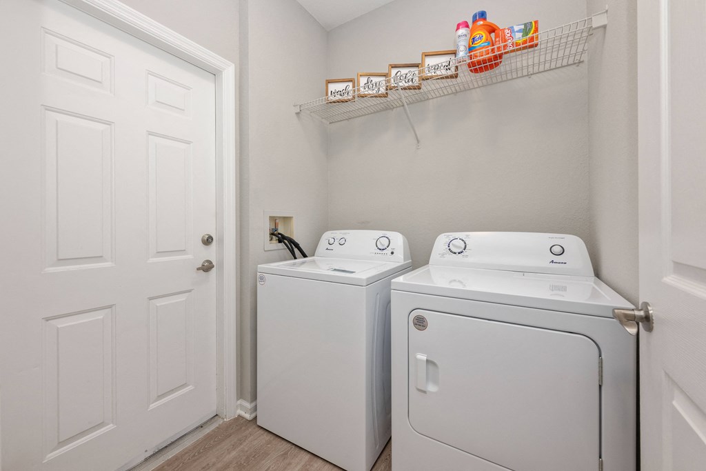 a washer and dryer in a laundry room with a white door