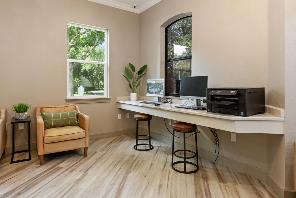 an office with a computer on a desk and a chair