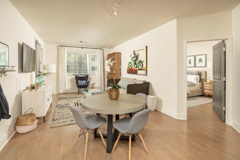 A dining room with a round table and chairs.