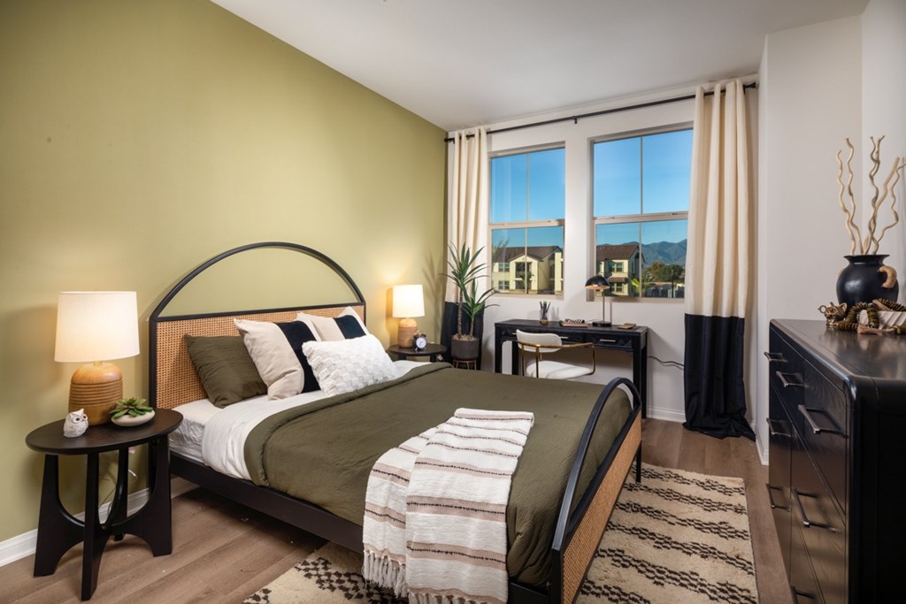 A bedroom with a large bed and a view of the city.