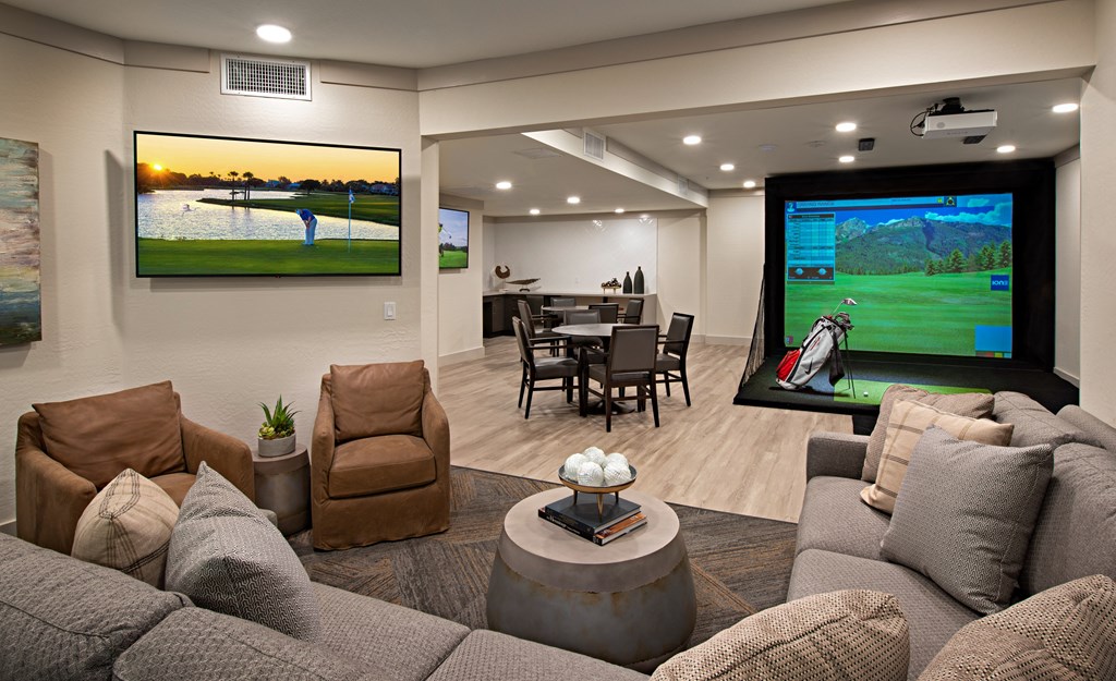 a living room with a large screen tv and a couch