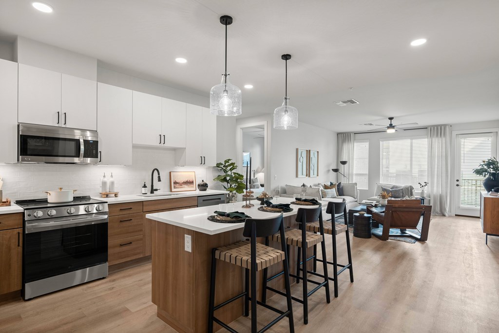 A modern kitchen with wooden cabinets and a large island.