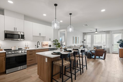 A modern kitchen with wooden cabinets and a large island.