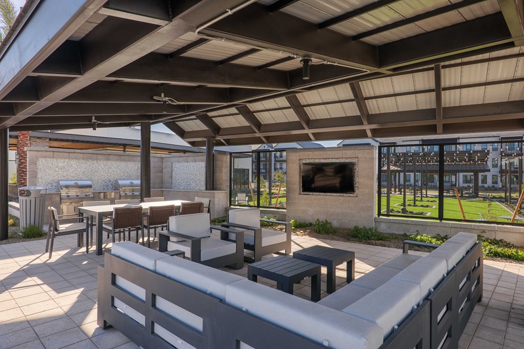 A patio with a fireplace and seating area.
