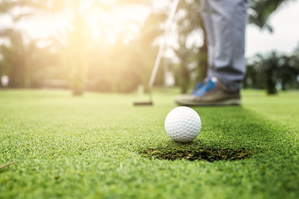 a golfer about to tee off on a golf course