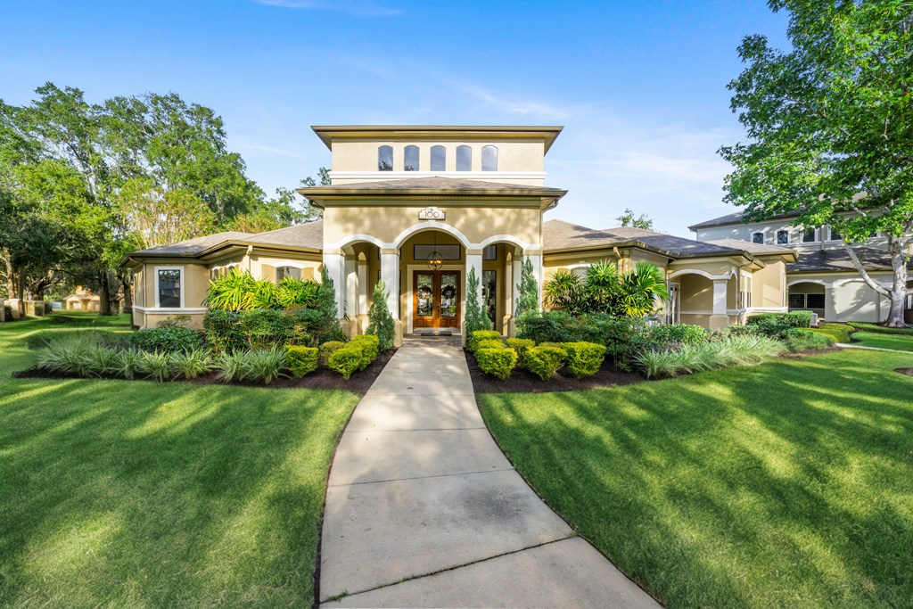 a house with a walkway and lawn in front of it