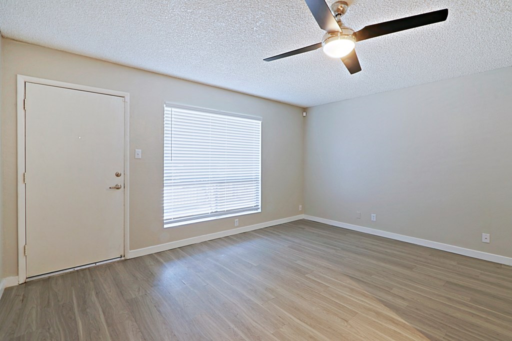 a bedroom with hardwood floors and a ceiling fan