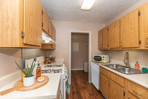 a kitchen with a stove top oven and a sink