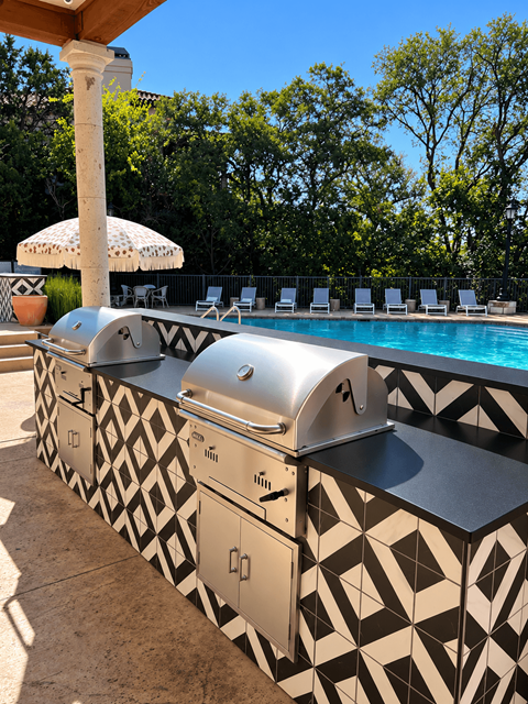 A poolside bar with a black and white patterned counter.