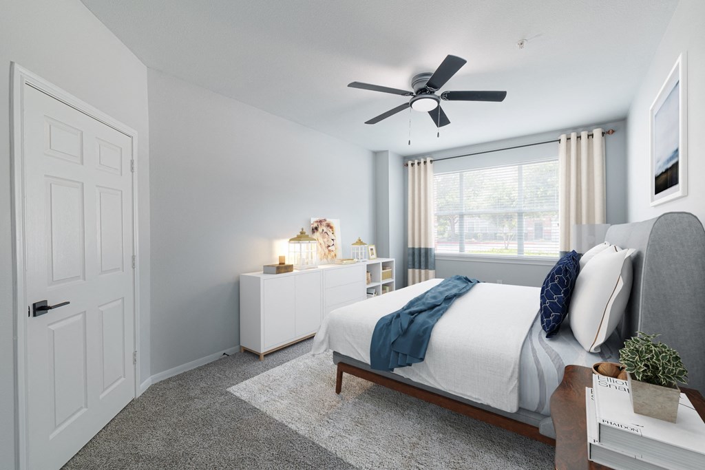 a bedroom with a bed and a ceiling fan