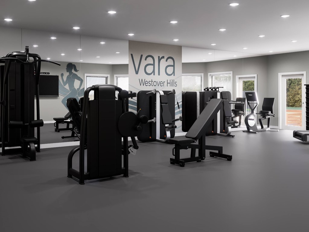 A gym with a variety of equipment including treadmills, weights, and exercise machines.