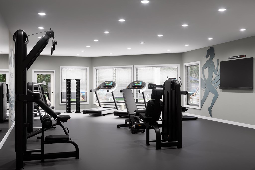 A gym with a variety of equipment including treadmills, weights, and exercise machines.