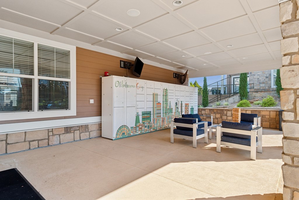 A room with a whiteboard and a stone wall.
