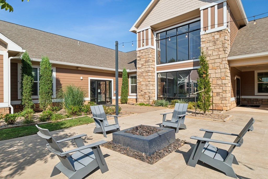 A house with a patio and four chairs.