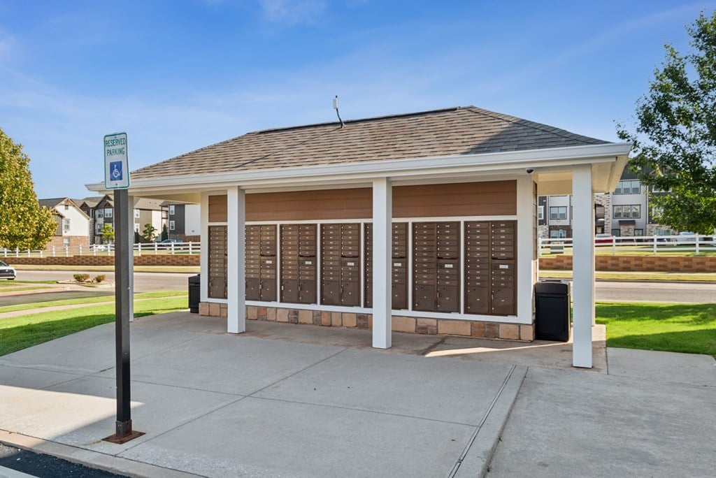 A covered waiting area with a sign for disabled parking.